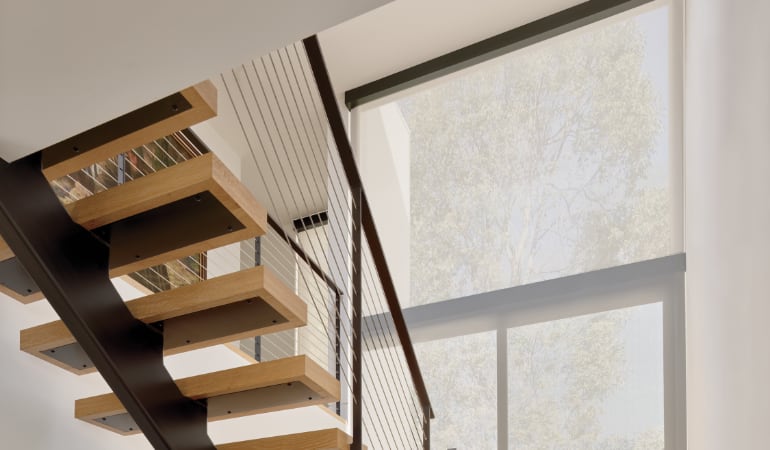 Motorized shades are easy to operate and can be controlled by a remote control or smart phone. Motorized shades in a home.